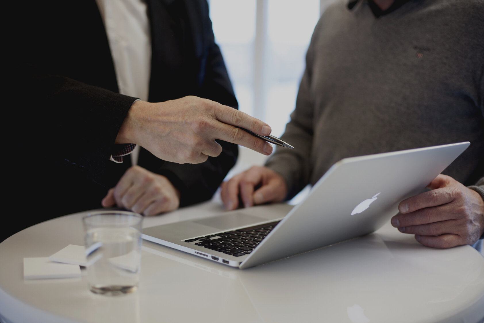 Businessmen In A Meeting At Desk With Laptop